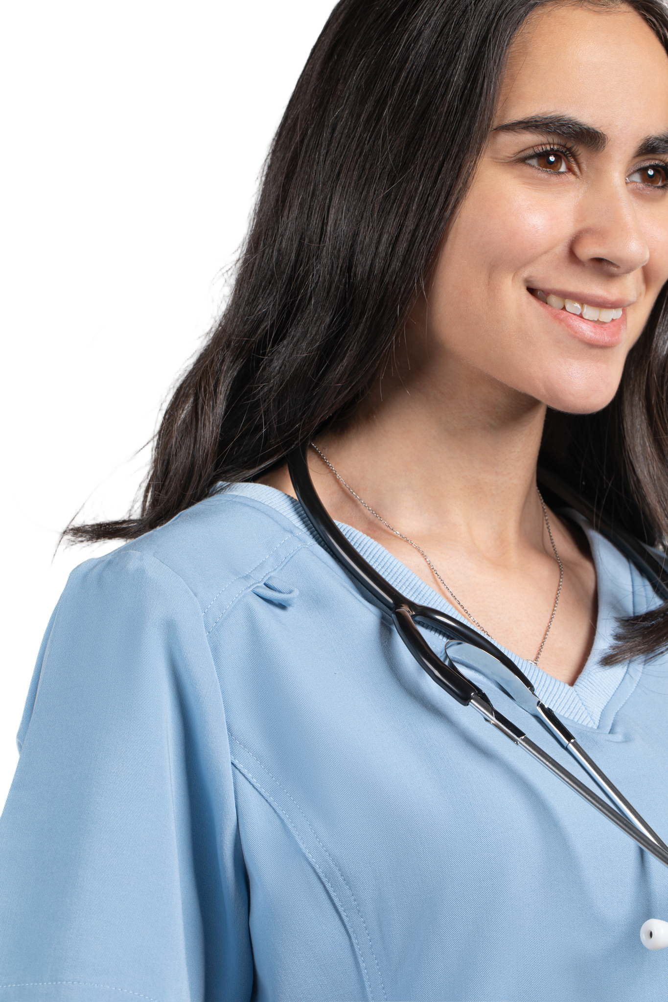 Woman wearing a light blue medical scrub top with a stethoscope around her neck, on a white background.