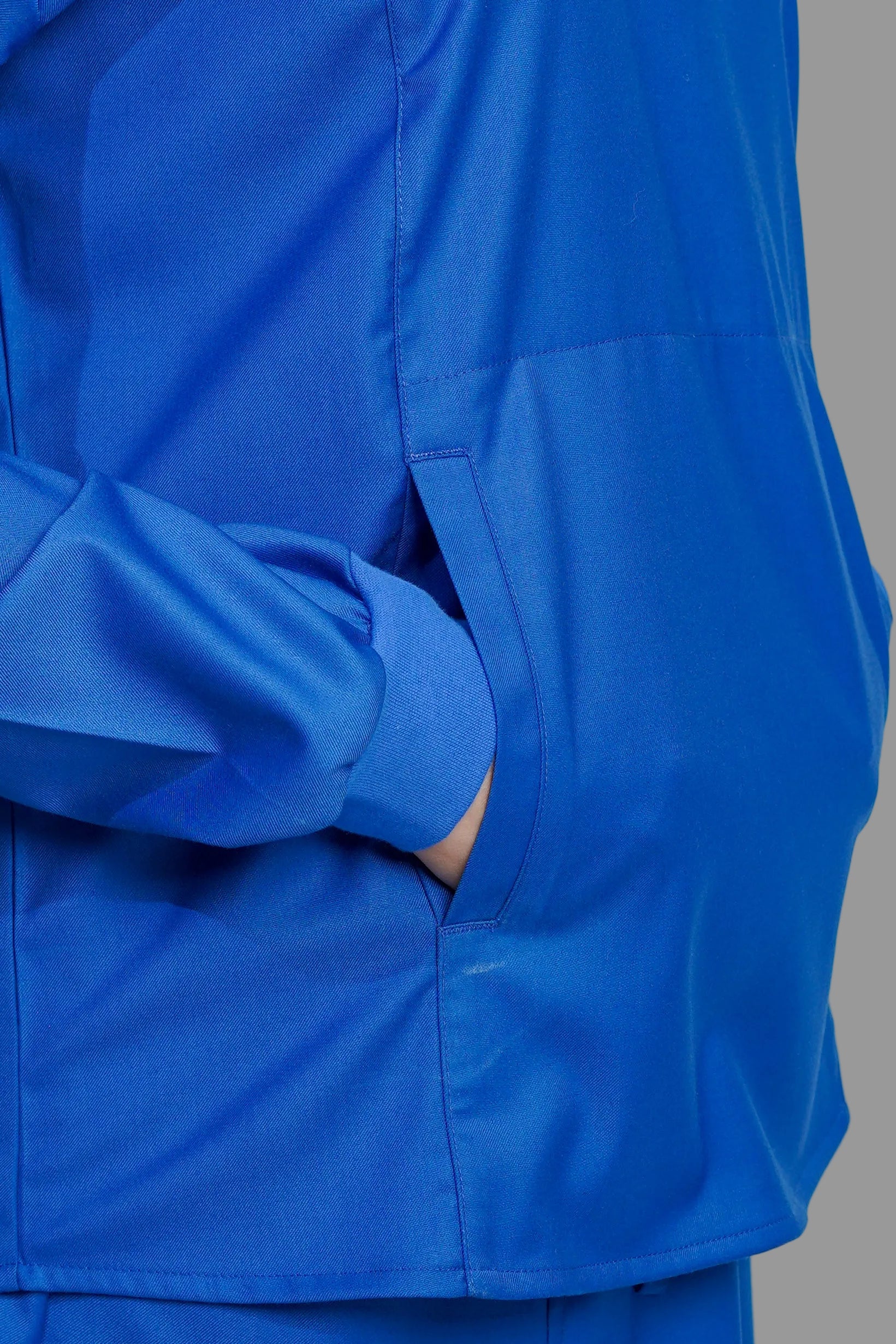 Blue raincoat with a pocket on a gray background