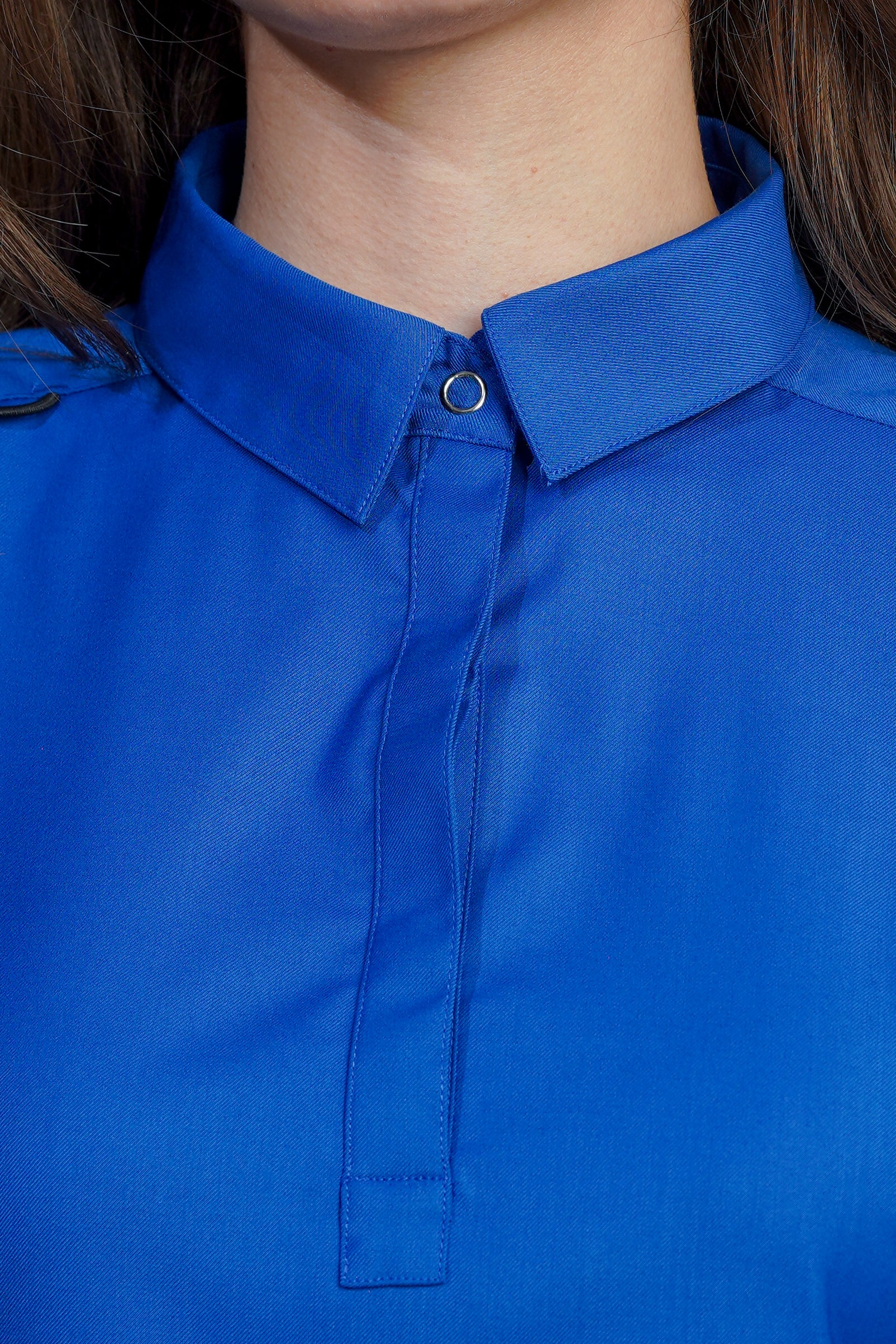 Close-up of a blue shirt with a collar