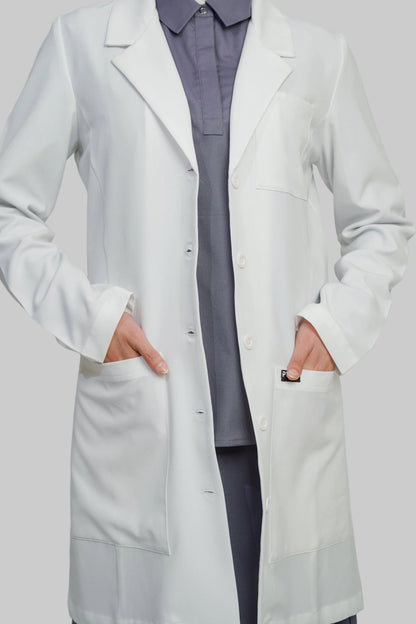 Person wearing a white lab coat over a gray outfit on a plain background