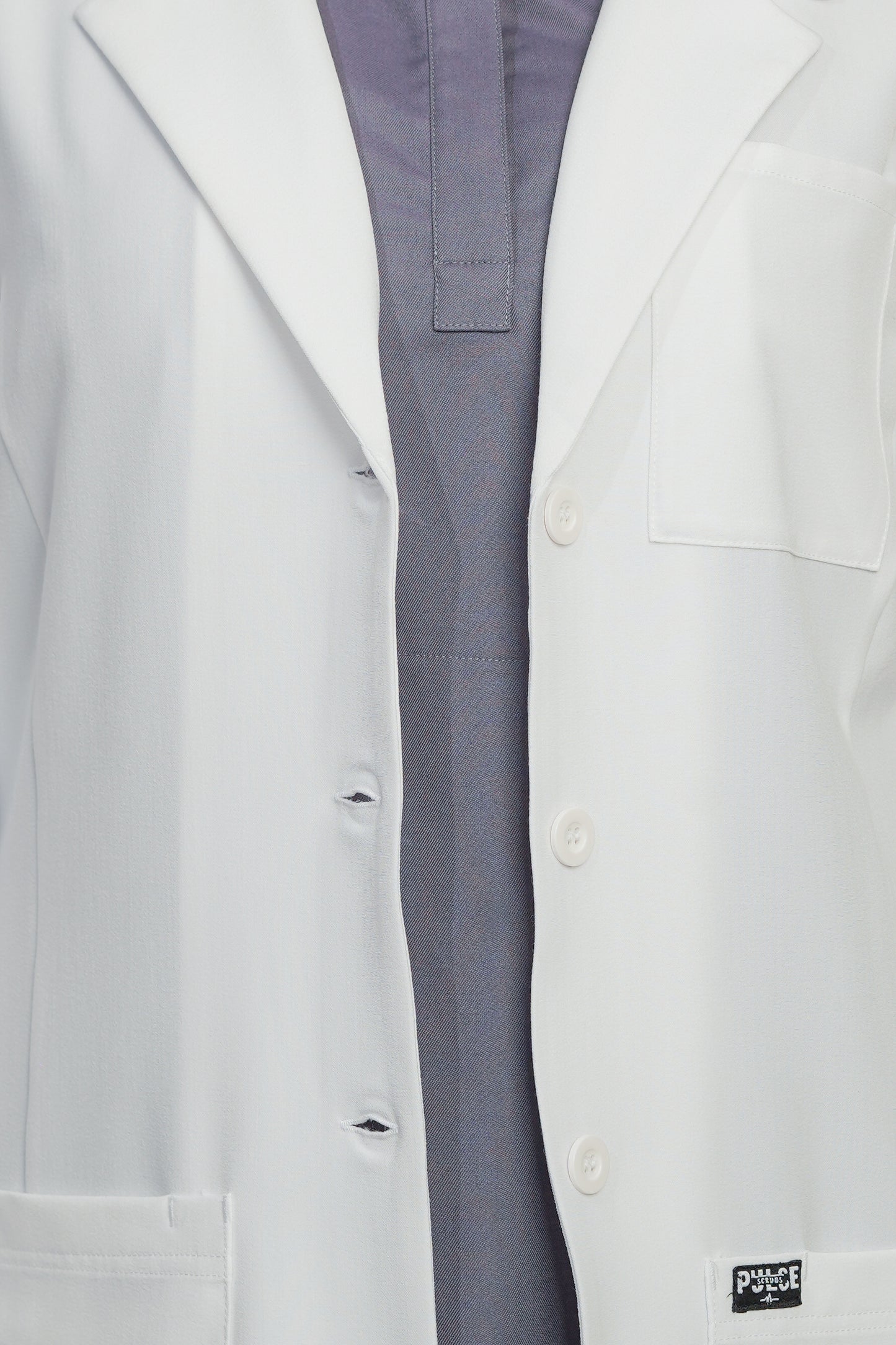 Close-up of a white lab coat with a visible brand logo on a white background