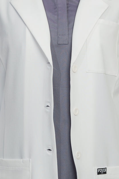 Close-up of a white lab coat with a visible brand logo on a white background