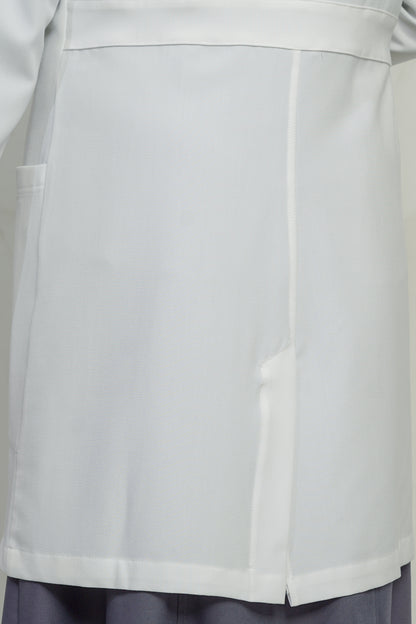 Close-up of a light gray coat with a pocket on a plain background