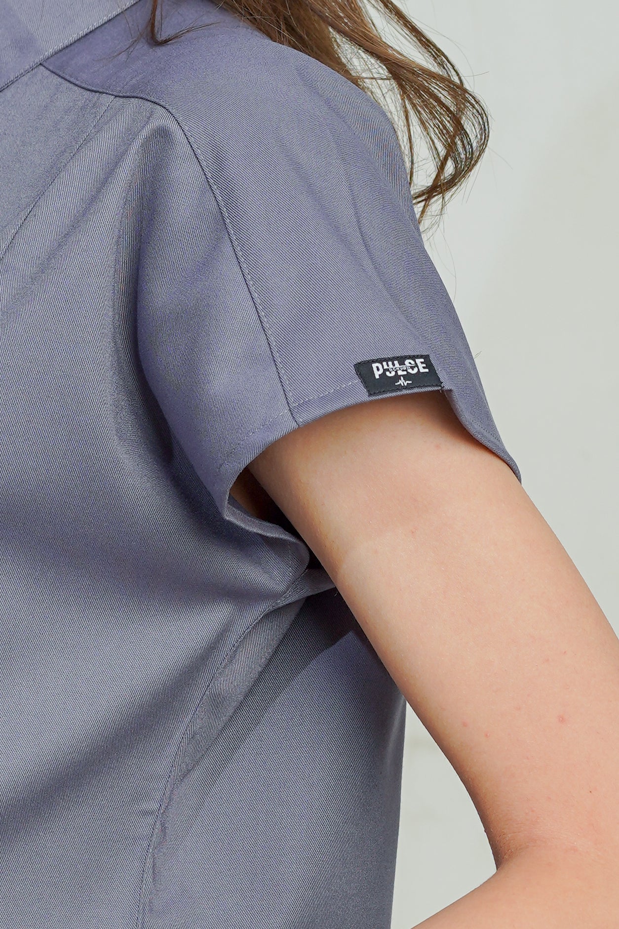 Gray shirt with a 'Pulse' label on a plain background
