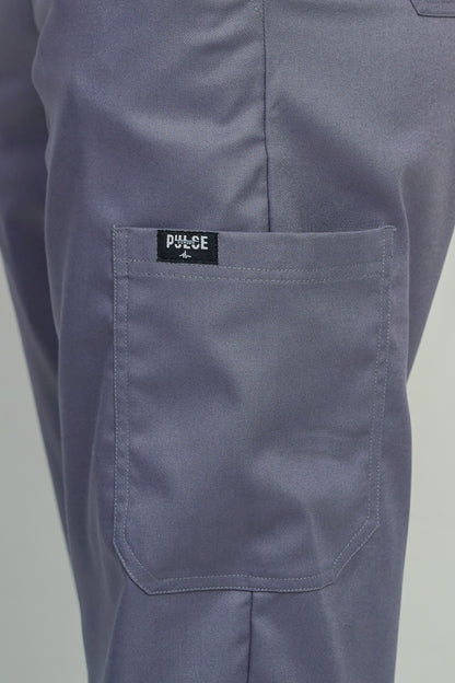 Close-up of a pocket on a pair of gray pants with a visible brand label.