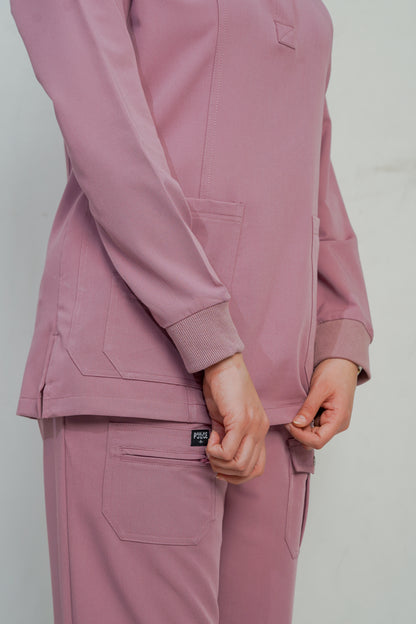 Person wearing a pink tracksuit against a plain background