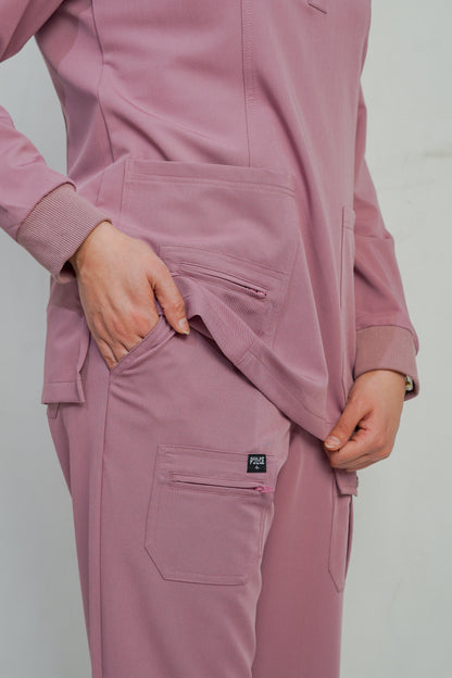 Pink tracksuit with a brand logo on a plain background