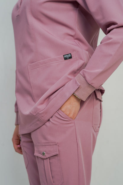 Pink tracksuit with a visible brand logo on a plain background
