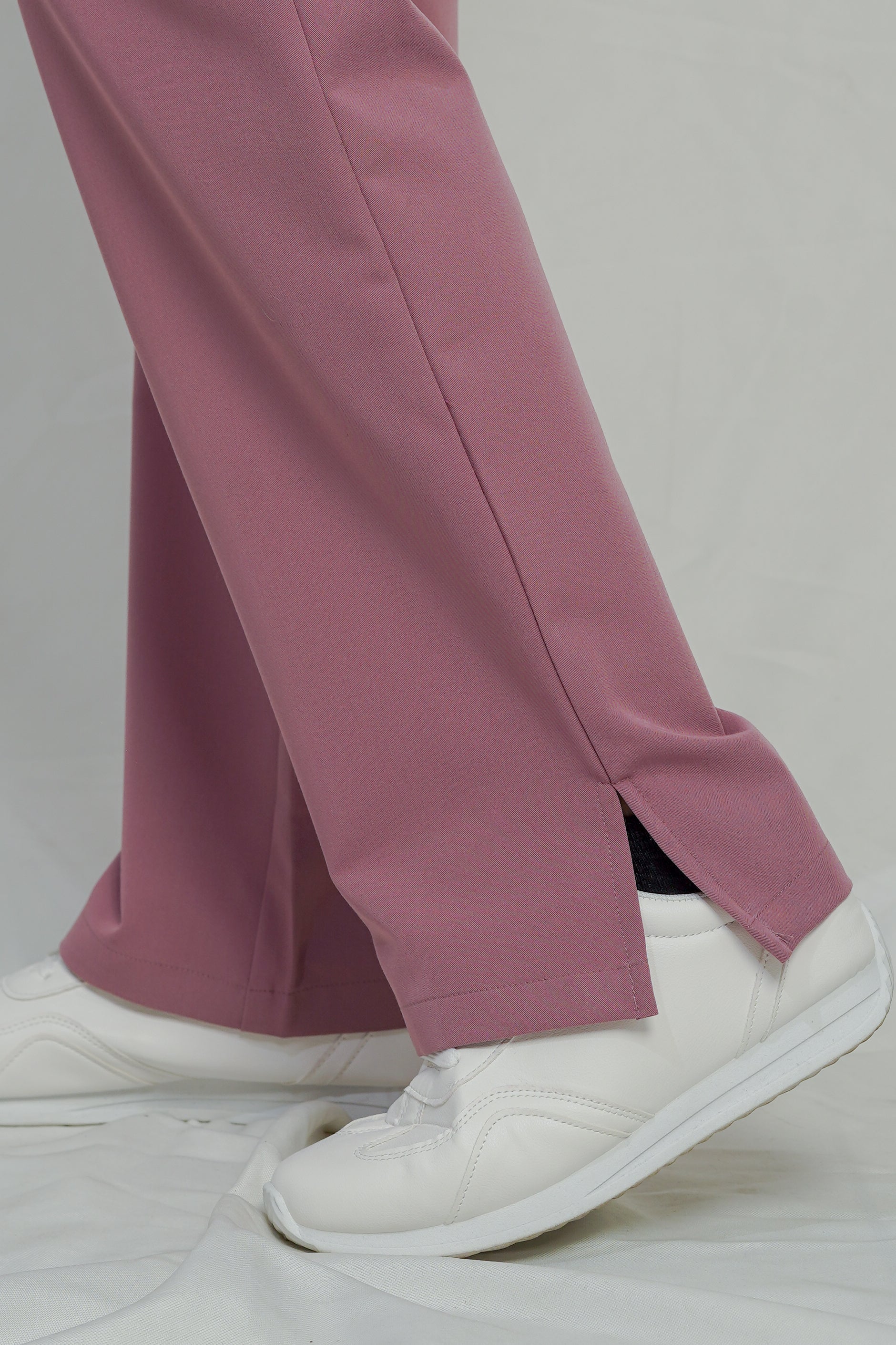 Purple pants and white sneakers on a plain background