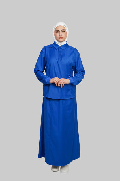 Person wearing a blue outfit with a white hijab on a gray background