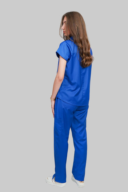 Woman wearing a blue scrub set against a white background