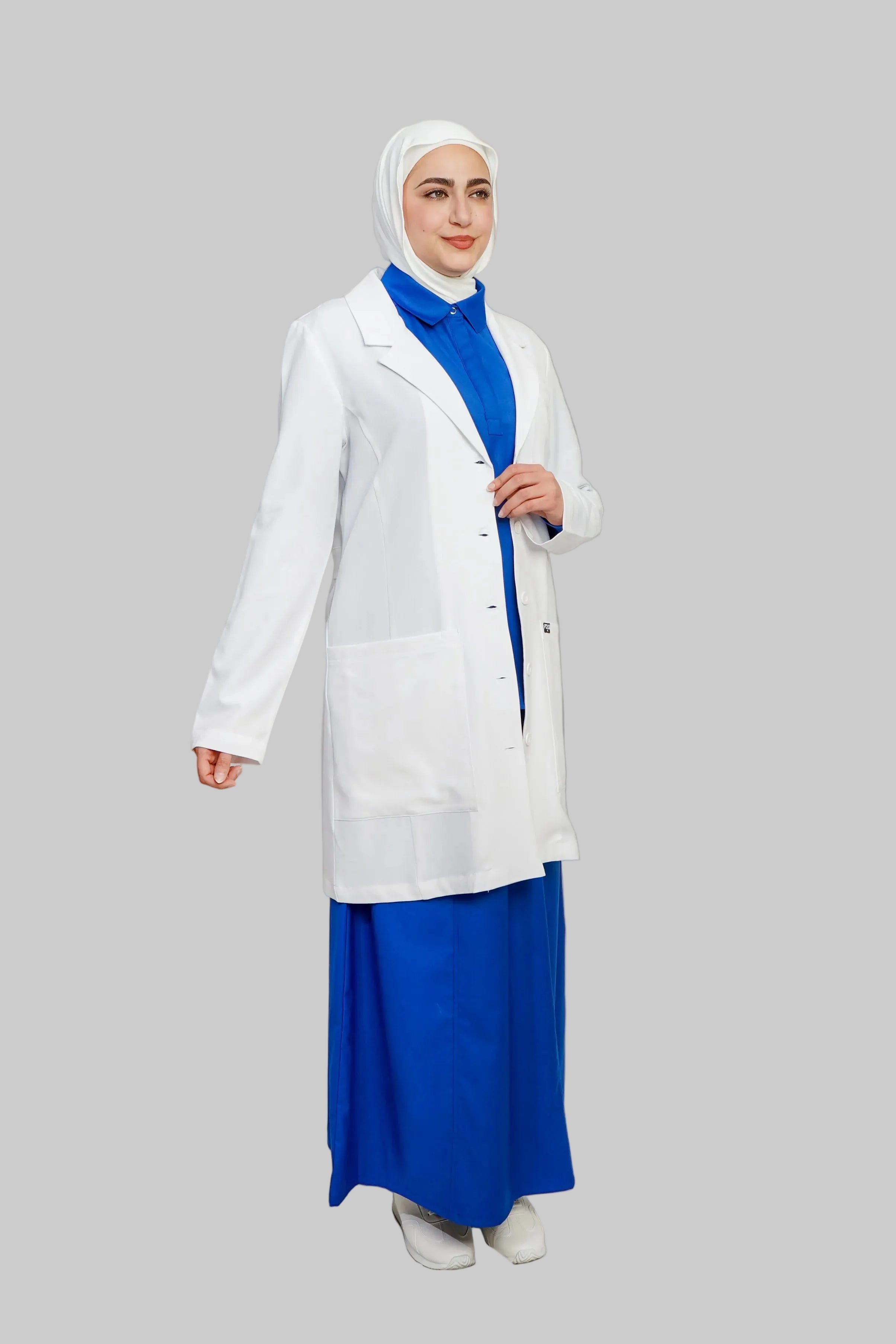 Person wearing a white lab coat over a blue outfit on a plain background