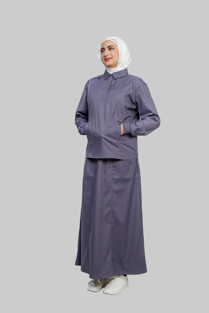 Woman wearing a gray outfit with a hijab on a white background