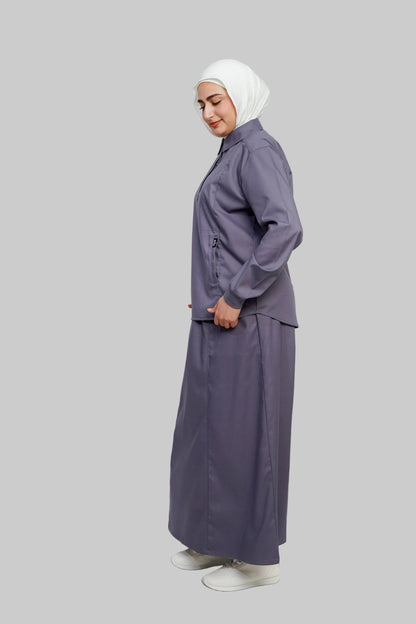Person wearing a matching purple outfit with a hijab on a white background