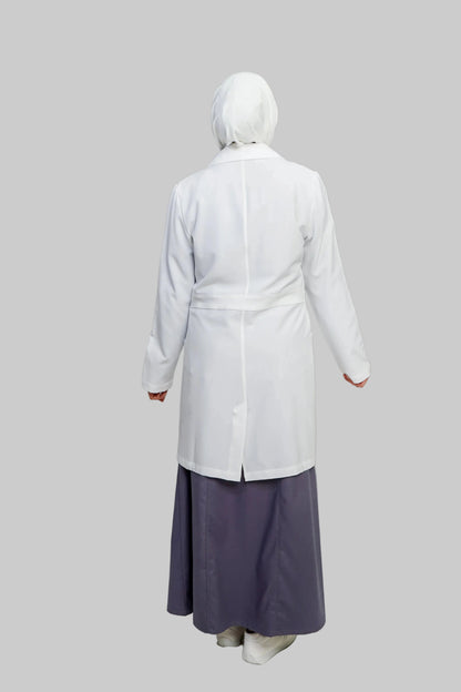 Person wearing a white coat and purple skirt on a plain background