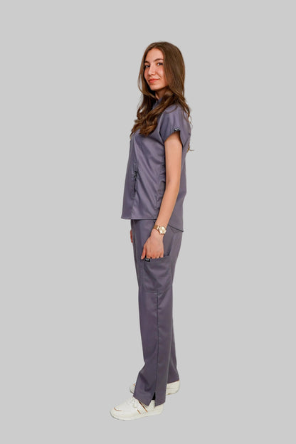 Woman wearing a gray scrub set on a white background