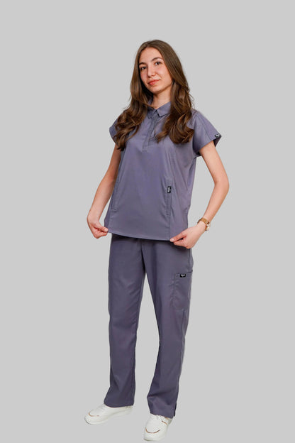 Person wearing a gray scrub set on a white background
